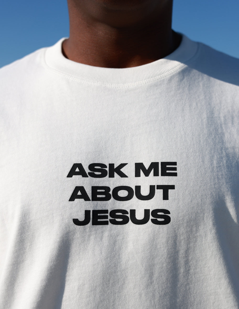 Black heavyweight T-shirt from Elevated Faith with "Ask Me About Jesus" printed front, casual fit, and bold religious message.