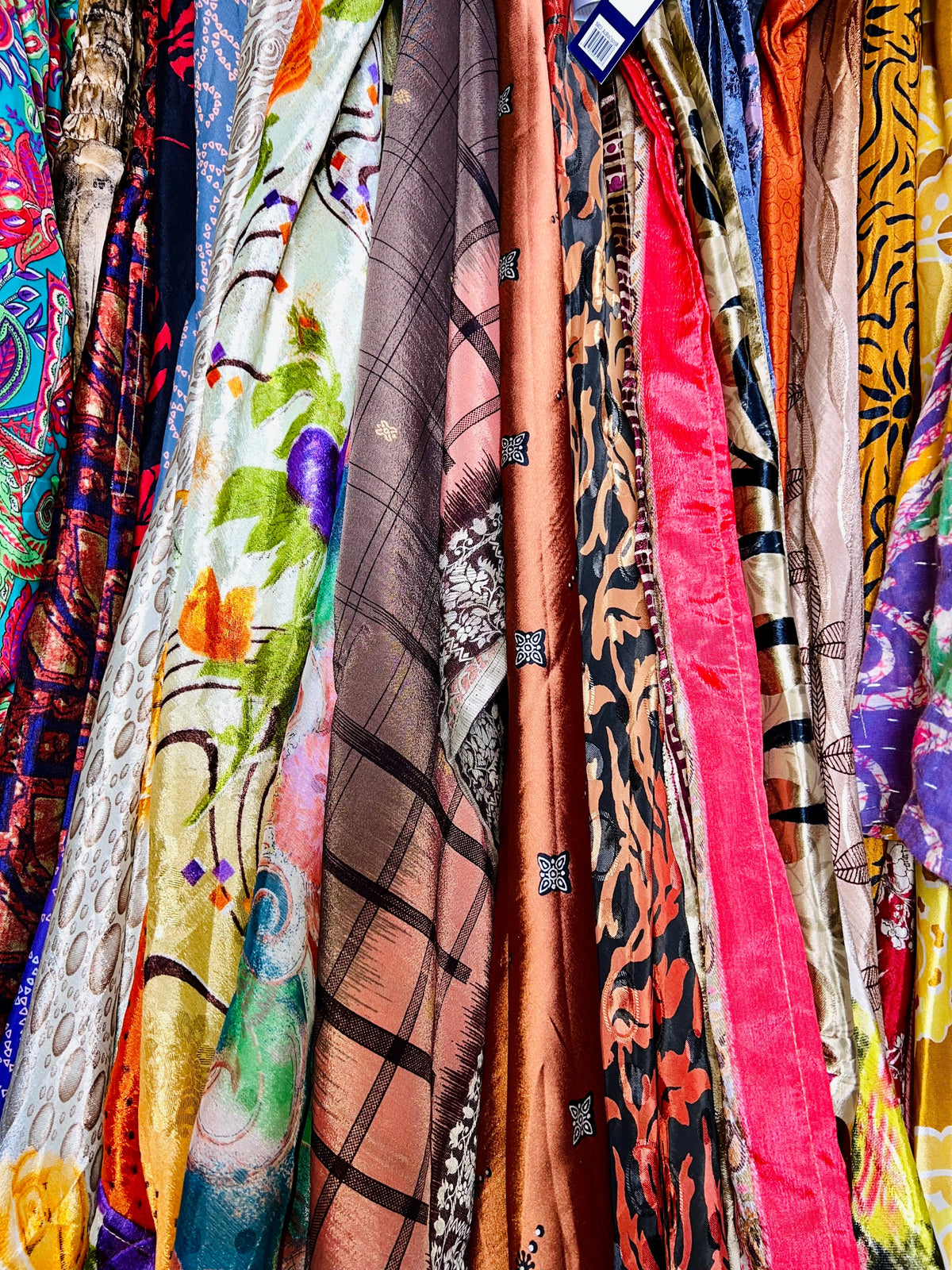 Darn Good Yarn Moonlit Market Apparel Bundle featuring colorful clothing and accessories with vibrant patterns and textures.