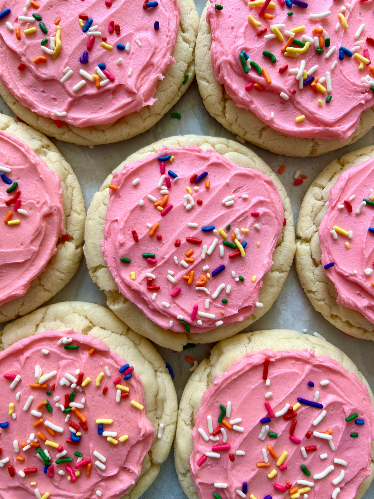 Frosted Sugar Cookie from Let's Get Baked Artisan Desserts with a sweet sugar glaze and festive sprinkles on a white plate.