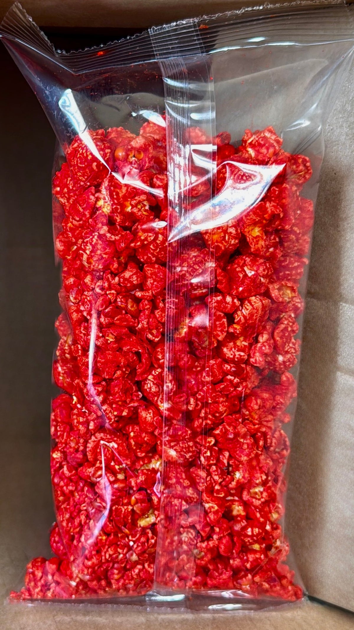 Junior Snacks Co. Hot Cheddar snack bag with colorful branding and spicy cheddar flavor packaging.