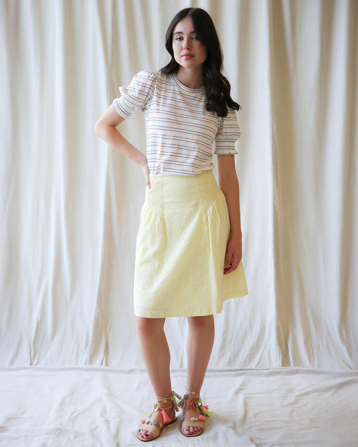 Downeast Off The Clock skirt in neutral fabric, featuring a fitted waist and A-line silhouette, styled with casual accessories.