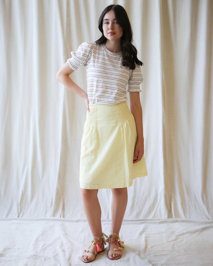 Downeast Off The Clock skirt in neutral fabric, featuring a fitted waist and A-line silhouette, styled with casual accessories.
