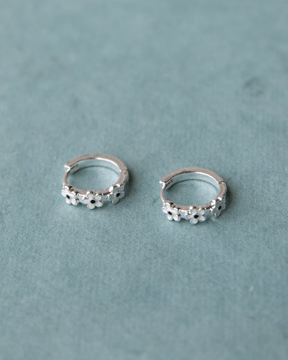 Silver In Bloom huggie hoop earrings by Downeast featuring delicate floral design and small hoop style.