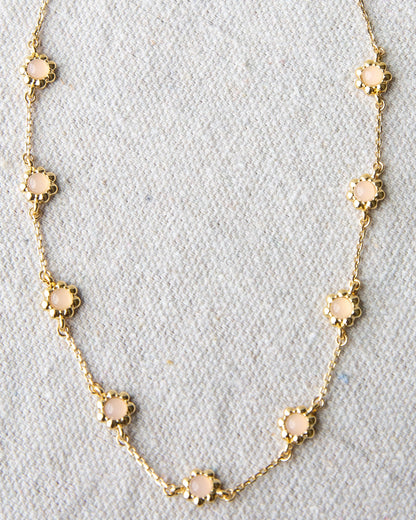 Delicate mini flower necklace from Downeast featuring a small floral pendant on a sleek chain.
