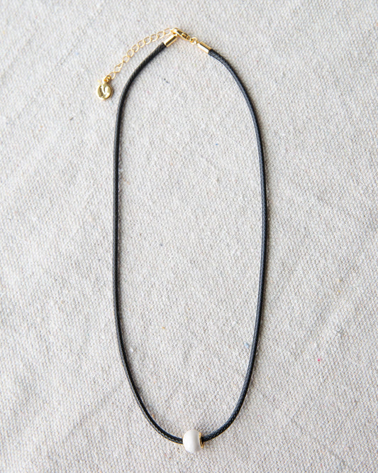 Downeast pearl and cord necklace with a delicate design, featuring white pearls and a black cord for a stylish accessory.