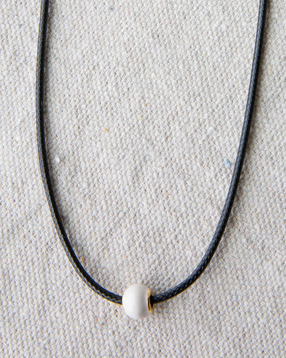 Downeast pearl and cord necklace featuring elegant white pearls on a stylish cord, perfect for casual or formal wear.