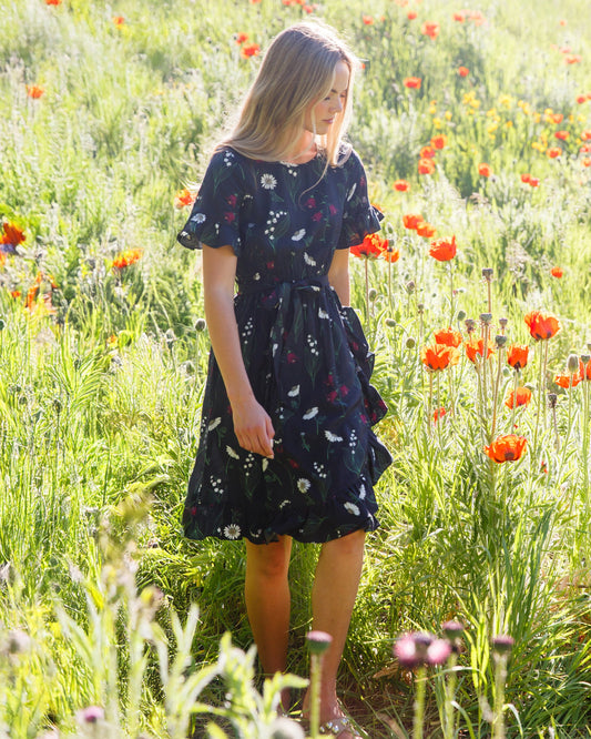 Downeast ruffle and wrap dress featuring a flowing design with ruffled details and a flattering wrap silhouette.