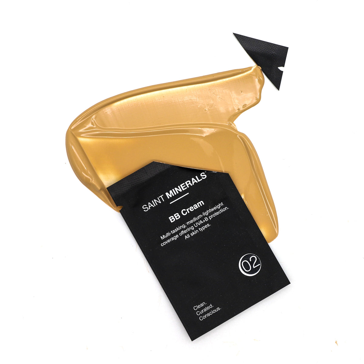 Panoply Beauty Saint Minerals BB Cream sample in a small container, showcasing smooth, light-colored cream for skin perfecting.