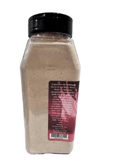 Creamy Hi-West Berry Berry Protein Shake in a glass with fresh berries and a straw, showcasing a delicious, fruity protein drink.
