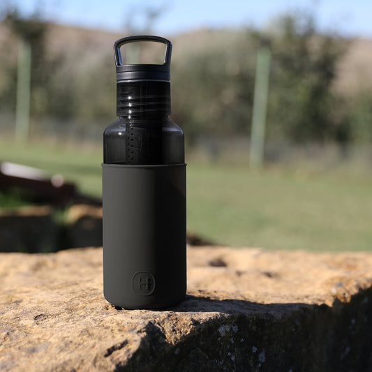 Charcoal-black HYDY 20 oz bottle with a sleek, matte finish and a screw-top lid, designed for durable hydration.