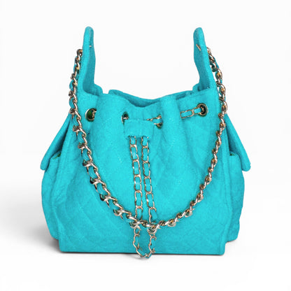 Small turquoise Bayshore Bucket by BEACH HAUS, showing a stylish, colorful beach bag with rope handles and a spacious interior.