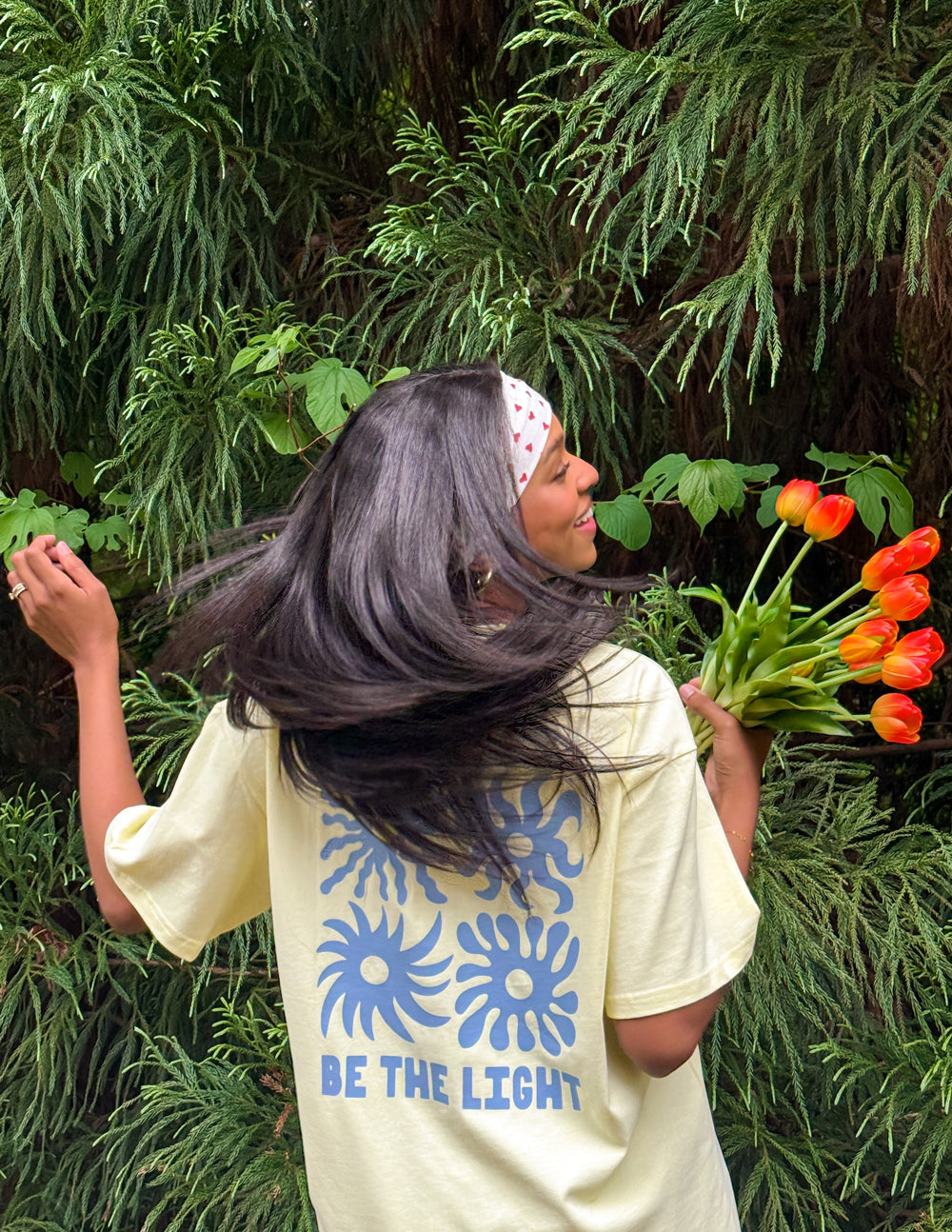 Unisex T-shirt by Elevated Faith featuring a "Be the Light" design, shown in a casual fit with a round neckline and light fabric.