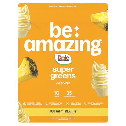 Be Amazing Super Greens powder in a jar with a Dole Whip Pineapple flavor label, showing vibrant green supplement contents.