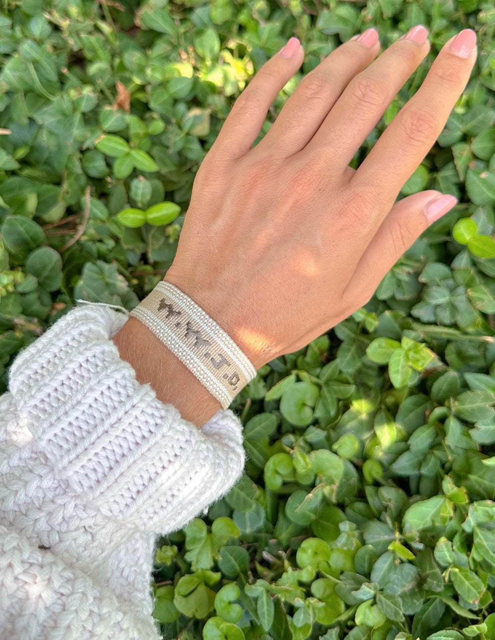 Beige WWJD embroidered bracelet wristband by Elevated Faith with stitched religious message on soft fabric.