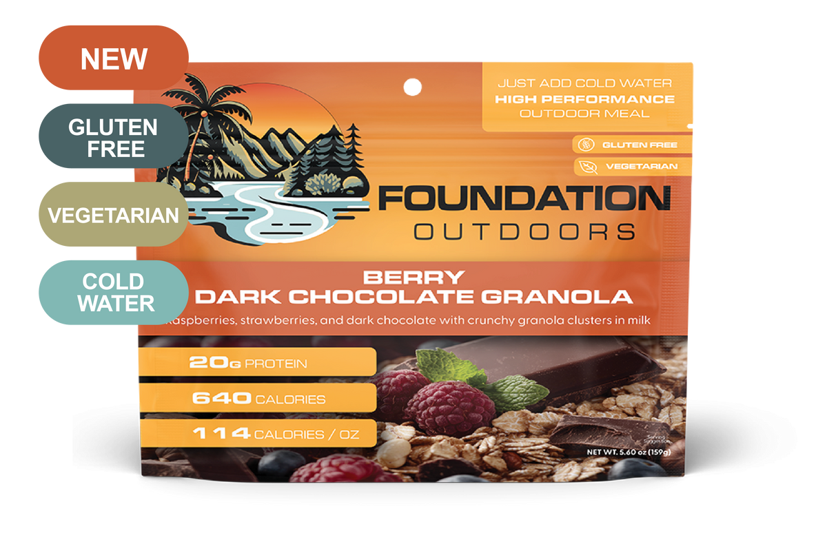 Crunchy Berry Dark Chocolate Granola from FOUNDATION Outdoors with vibrant berries and chocolate chunks in a natural setting.