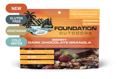 Crunchy Berry Dark Chocolate Granola from FOUNDATION Outdoors with vibrant berries and chocolate chunks in a natural setting.