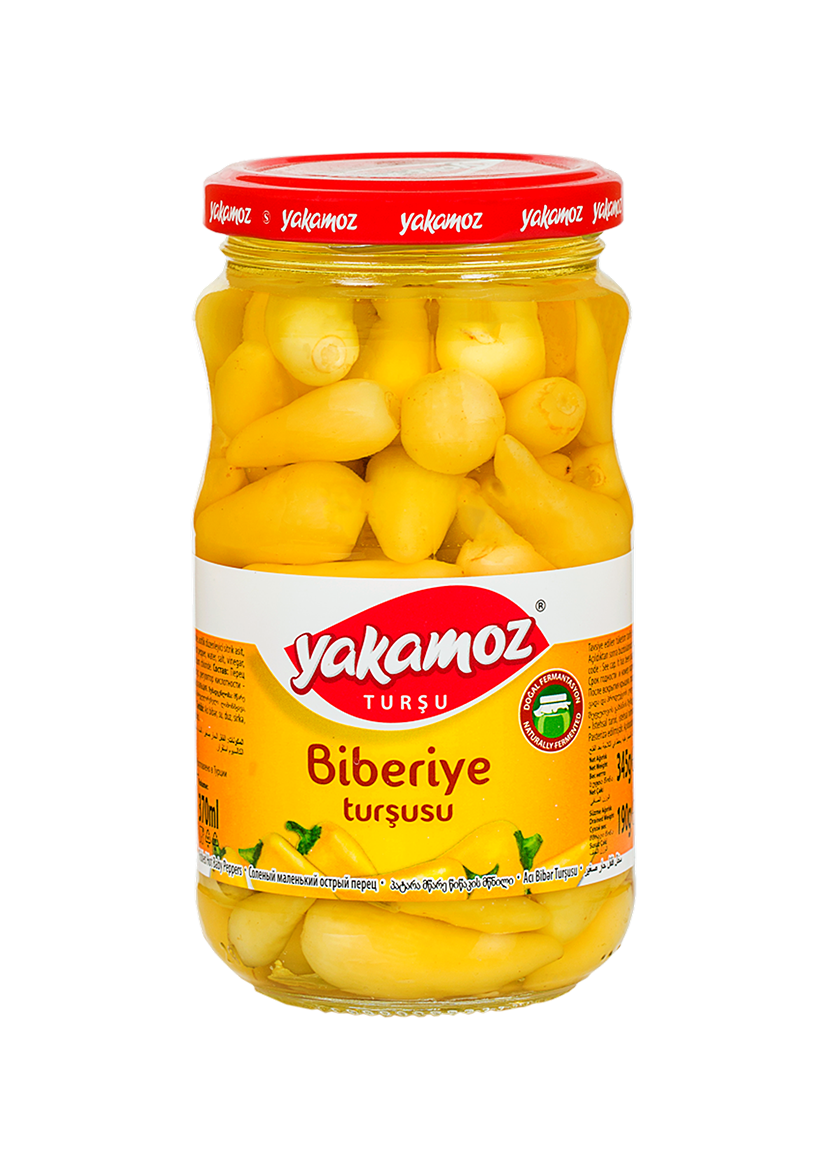 Glass jar of S101 Yakamoz Hot Baby Pepper Pickles with fresh peppers and herbs, ready for adding spicy flavor to dishes.
