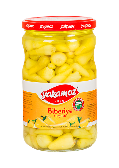 Glass jar of Yakamoz Hot Baby Pepper Pickles by S101, featuring vibrant red baby peppers and fresh herbs inside.