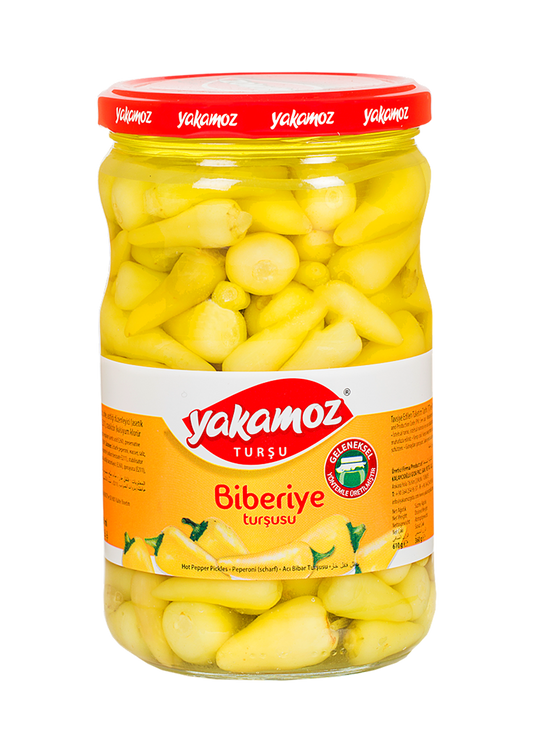 Glass jar of Yakamoz Hot Baby Pepper Pickles by S101, featuring vibrant red baby peppers and fresh herbs inside.