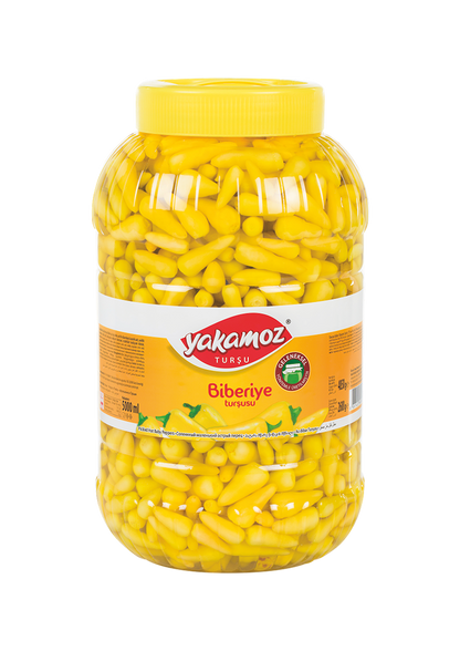 Glass jar of Yakamoz Hot Baby Pepper Pickles by S101, featuring vibrant red baby peppers and fresh herbs inside.