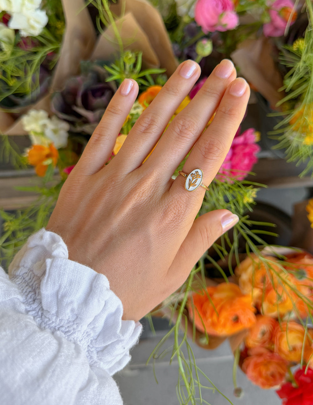 Elevated Faith Bloom Again enamel ring featuring vibrant floral design on a silver band, close-up of detailed craftsmanship.