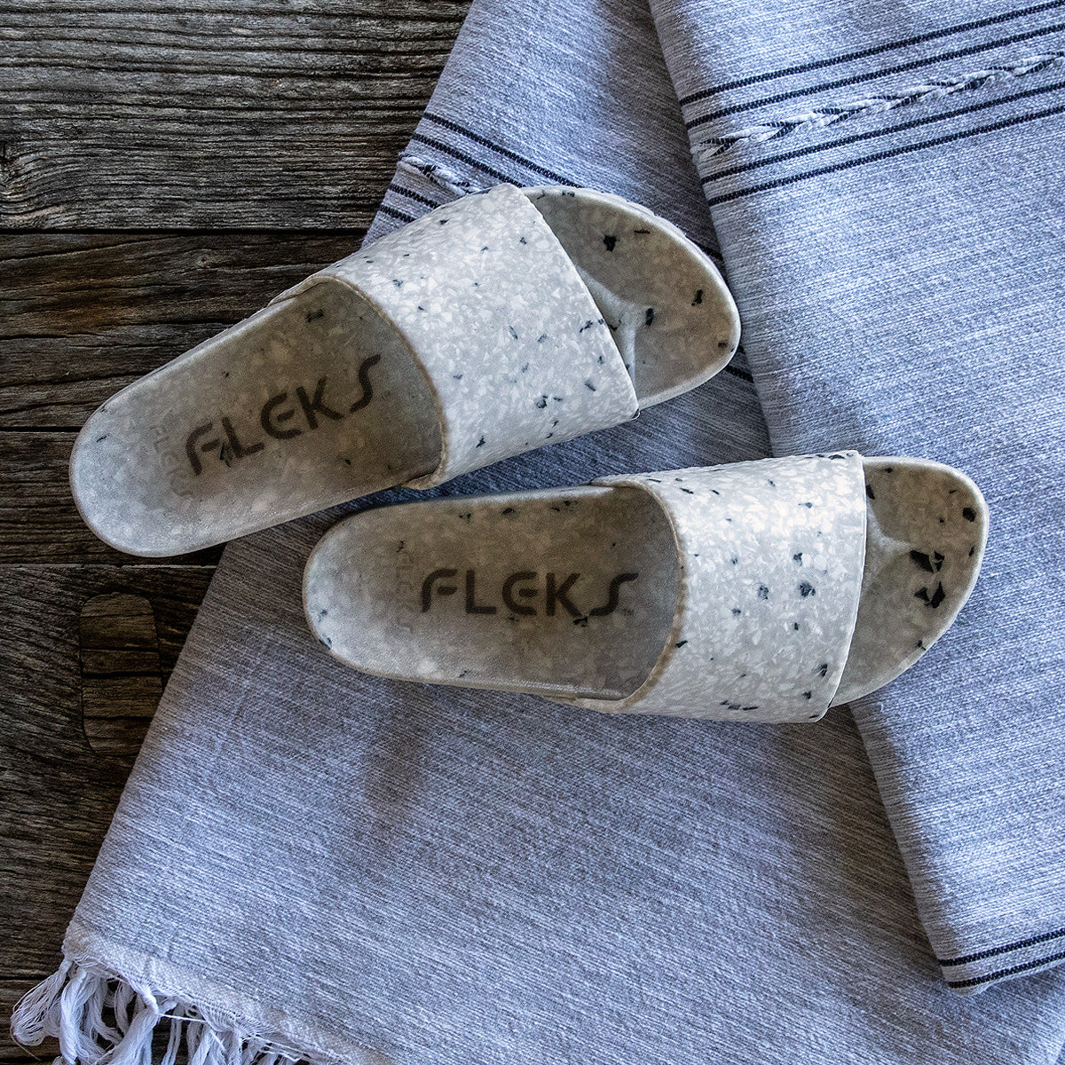Fleks East Beach Slide in cloudy weather showing comfortable slip-on design with cloud-patterned straps and cushioned footbed