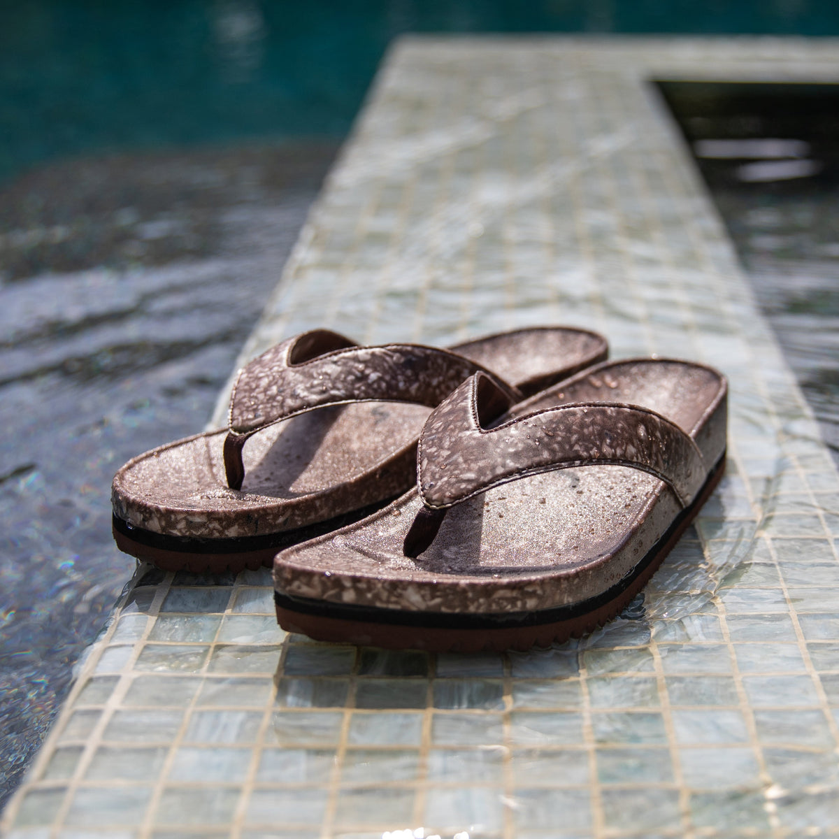Fleks West Beach Flip Flop with coconut shell design, featuring tan straps and a textured sole for beach comfort.