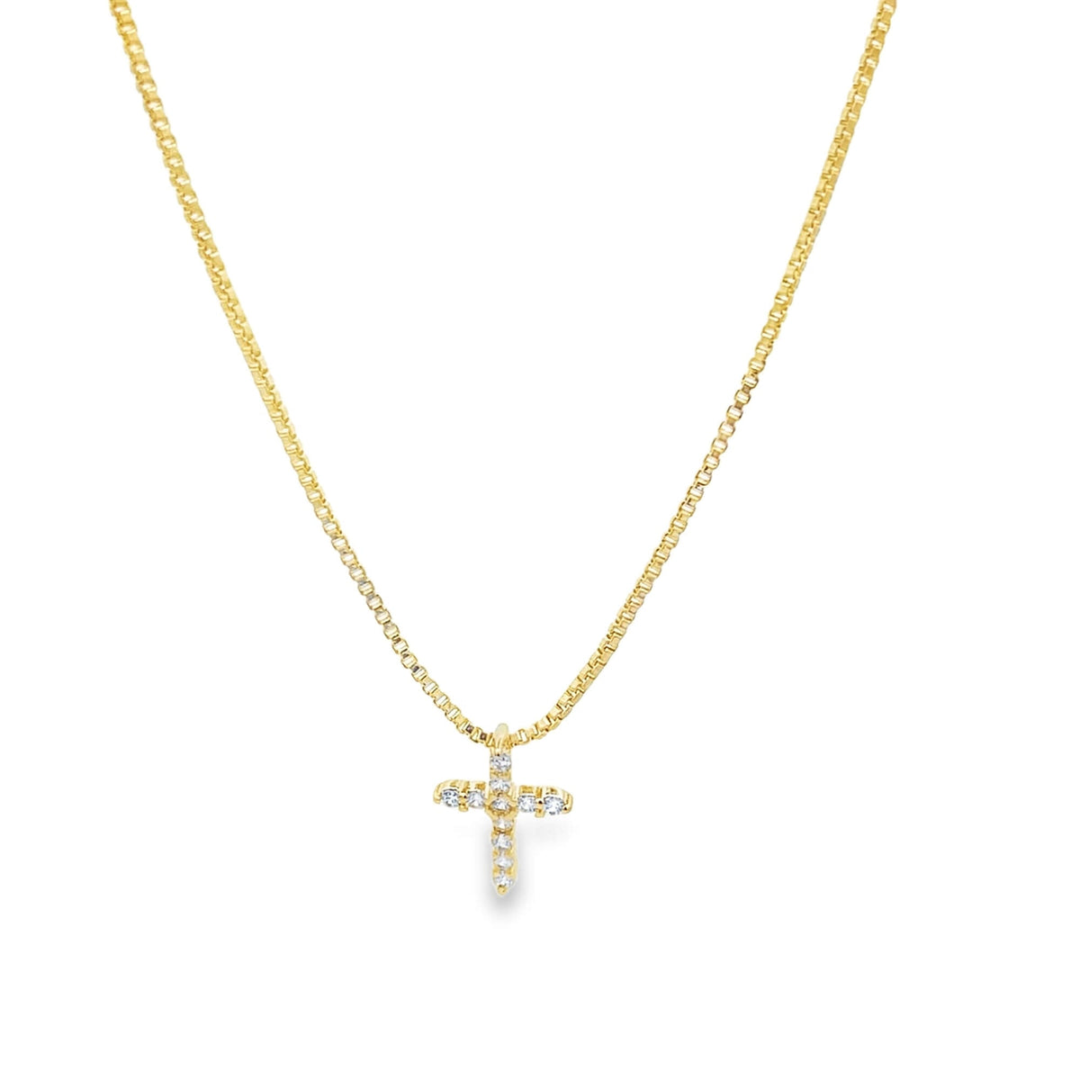 Dainty gold CZ pave cross pendant on a box chain necklace by Mia Jewelry, showcasing a sparkling religious jewelry piece.