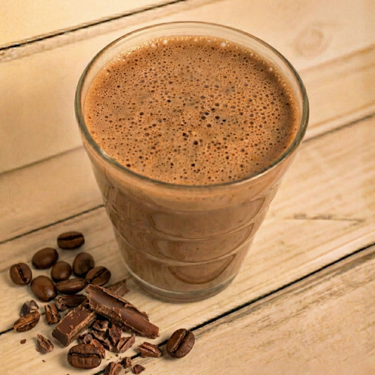 AmBari Nutrition Cafe Mocha Shake in a glass with whipped cream and chocolate drizzle, showcasing a creamy coffee-flavored protein shake.