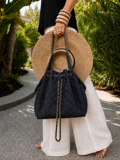 Medium Bayshore Bucket Bag by BEACH HAUS in dark wash denim, featuring a casual bucket style with a drawstring closure and shoulder strap.