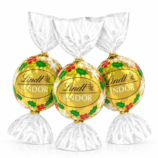 Assorted Lindt LINDOR White Chocolate Truffles in holiday wrappers from Candy In Bulk, displayed in a bulk value bag.