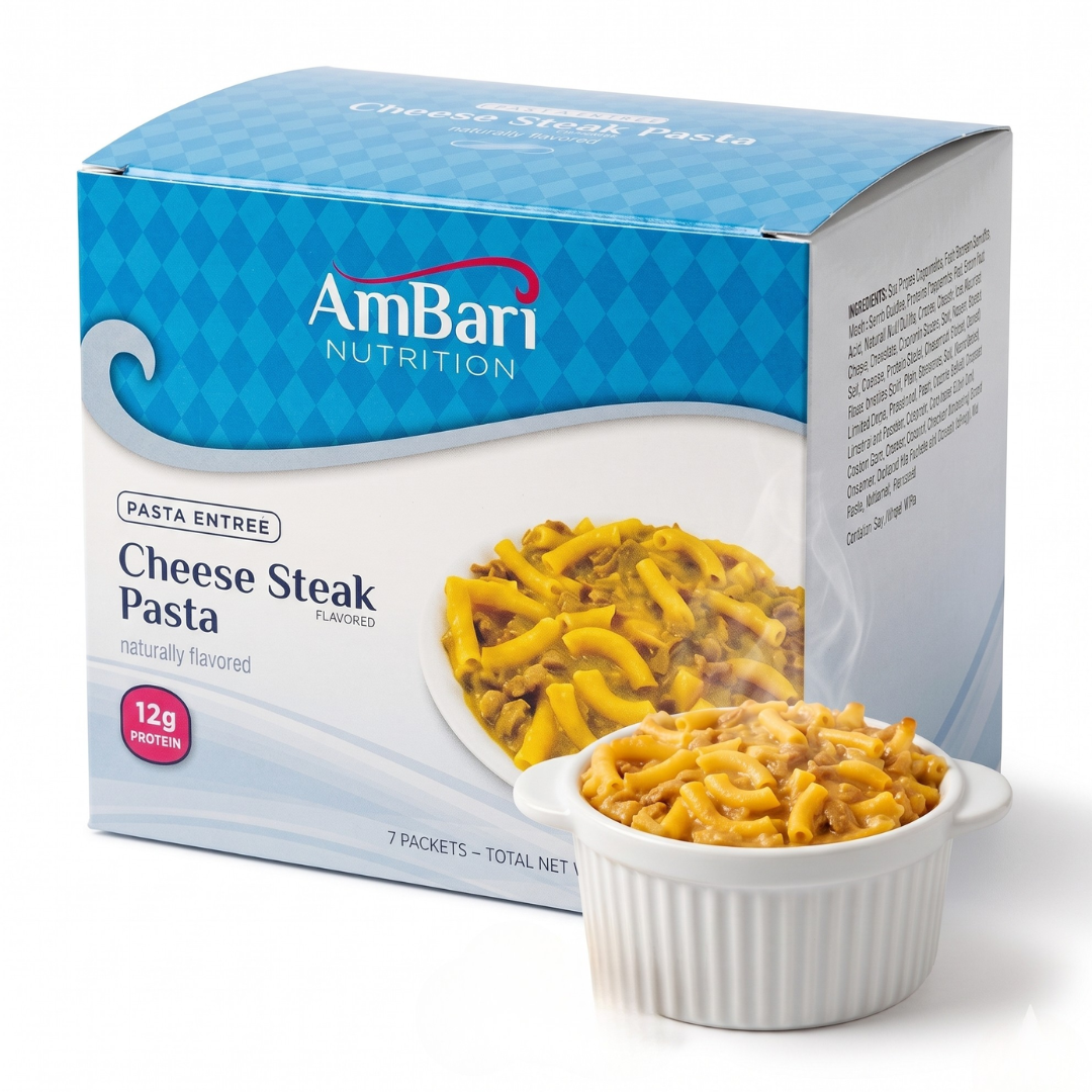 AmBari Nutrition CheeseSteak Pasta food dish with melted cheese, sliced steak, and pasta on a plate.