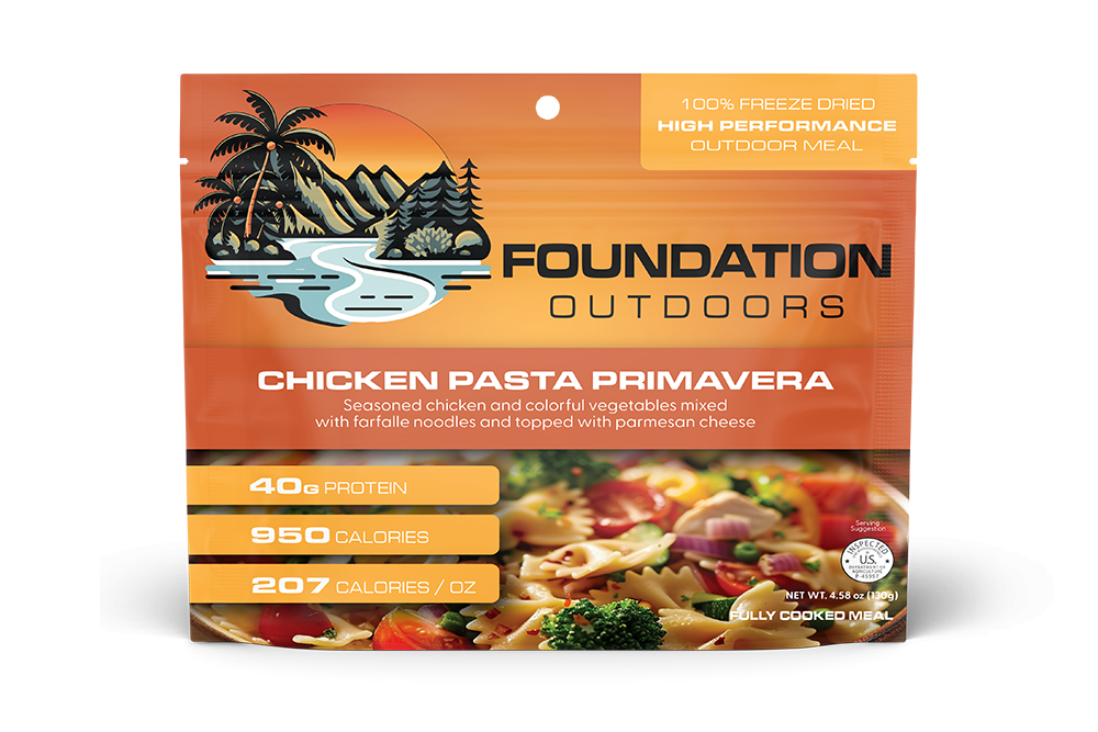 Foundation Outdoors Chicken Pasta Primavera meal pouch showing cooked chicken, pasta, and colorful vegetables in a ready-to-eat meal.