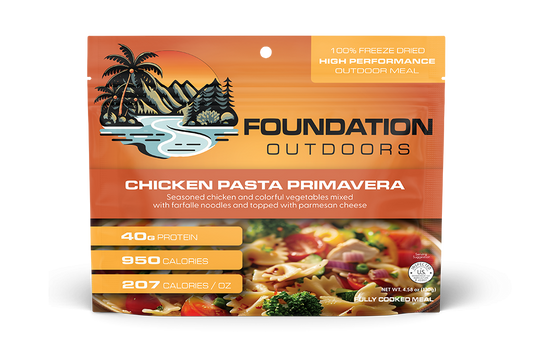 Foundation Outdoors Chicken Pasta Primavera meal pouch showing cooked chicken, pasta, and colorful vegetables in a ready-to-eat meal.