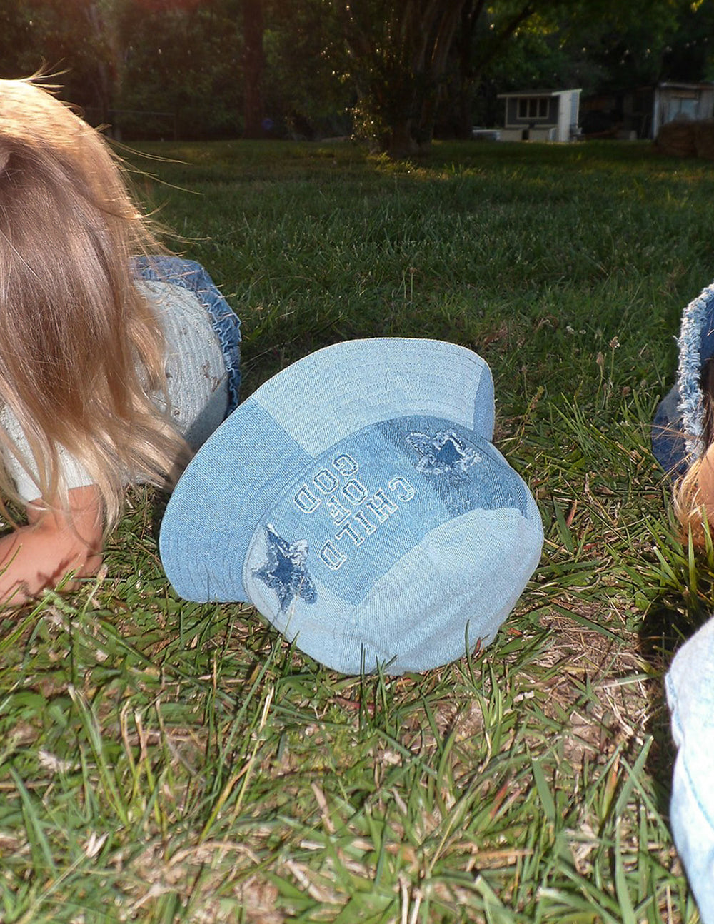 Child of God denim kids bucket hat by Elevated Faith with a wide brim and embroidered design for children’s outdoor wear.