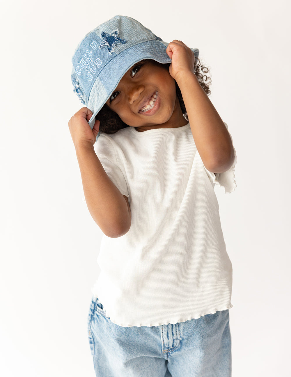 Kids denim bucket hat with "Child of God" embroidered design by Elevated Faith, perfect for children’s casual wear.