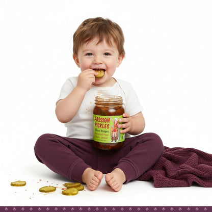 Spicy Passion Pickles® Ghost Pepper Homestyle Chips by Cinderosa Ranch in a jar with visible ghost peppers and crunchy pickle slices.