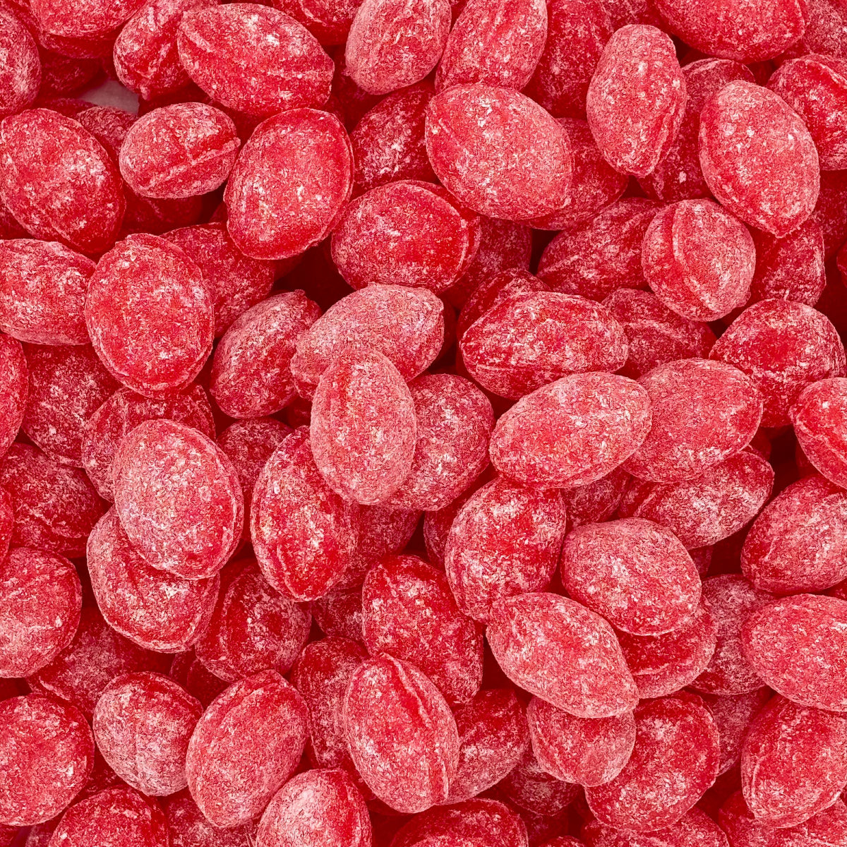 Claeys Wild Cherry Sanded Drops hard candy in a bulk value bag, showcasing the bright red cherry-flavored candies with a sanding sugar coating.