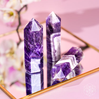 Chevron Amethyst point of transformation from Conscious Items, a crystal home decoration featuring a purple and white striped stone.