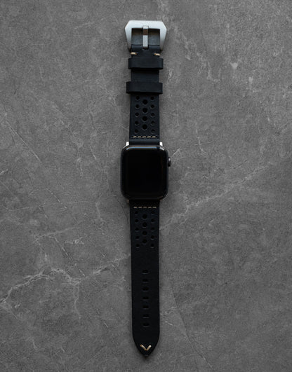 Close-up of Robust racing leather strap with detailed stitching and sturdy buckle, showcasing craftsmanship and premium leather material.