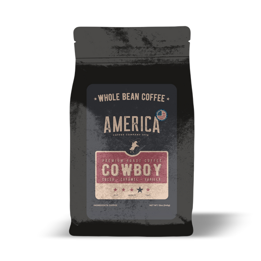 Whole coffee beans from America Supply Company LLC's Cowboy Blend, showcasing dark roasted beans in a natural, close-up view.