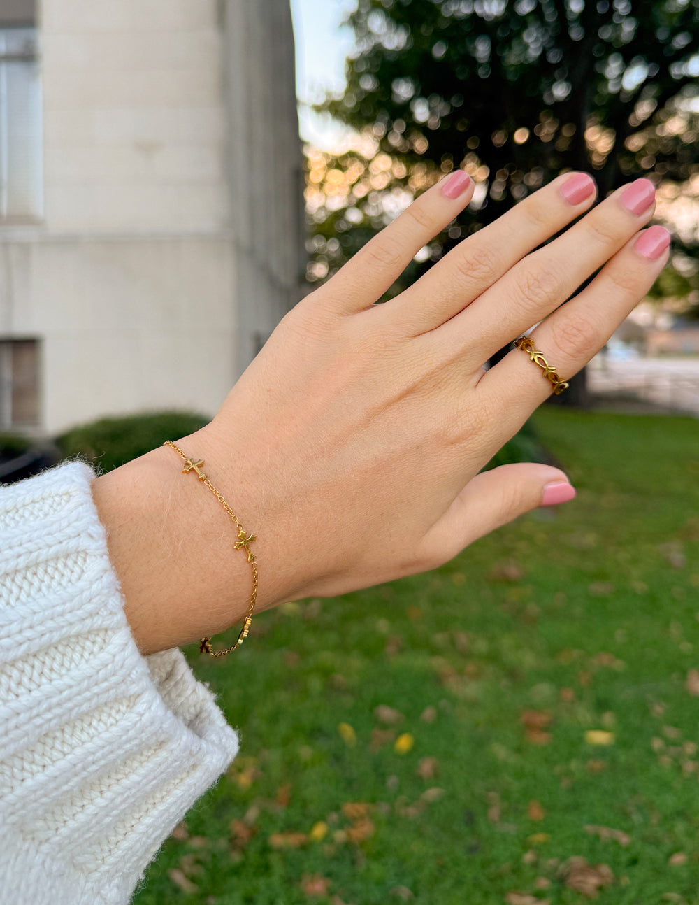 Elevated Faith cross link bracelet with metal links, featuring a religious cross charm and adjustable chain for stylish wear.