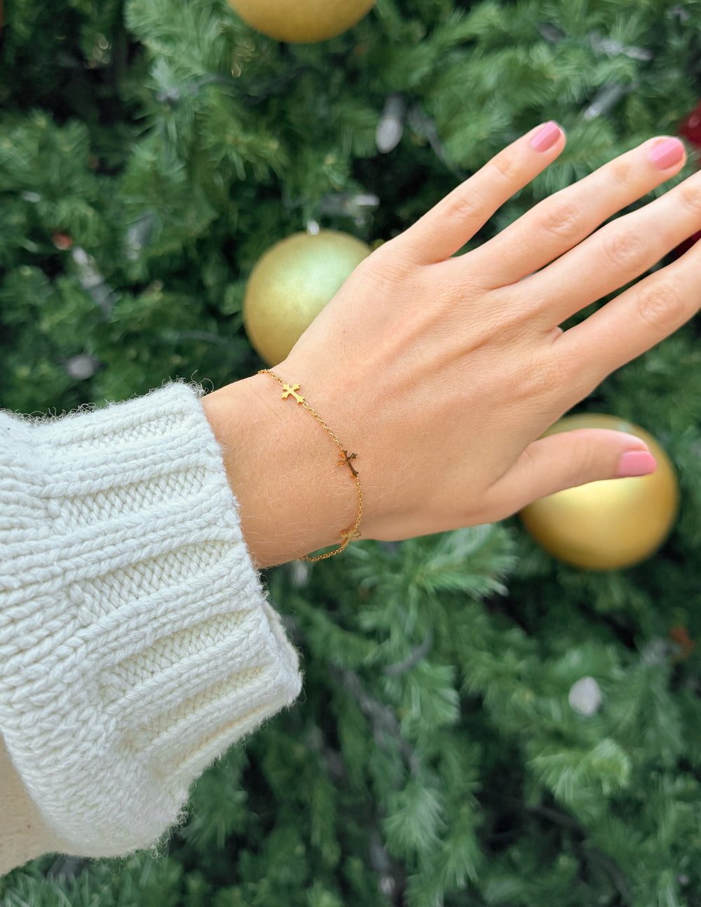 Elevated Faith cross link bracelet featuring interconnected metal links and a religious cross charm on a neutral background.