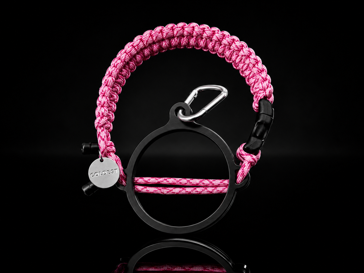 Coldest Paracord Handle accessory with pink and black design on a dark background, showcasing durable woven paracord material.