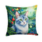 Decorative pillow featuring an Ojos Azules cat by a Christmas tree, from Caroline's Treasures, on a festive holiday setting.