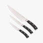 Black Dura Living Elite 3-piece kitchen knife set with stainless steel blades and black handles, displayed on a wooden surface.