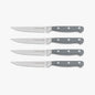 Set of four gray Dura Living steak knives with stainless steel blades, arranged on a wooden table for dining.