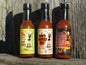 Three bottles of Cinderosa Ranch hot sauces in a combo set, featuring colorful labels and spicy flavors on a white background.