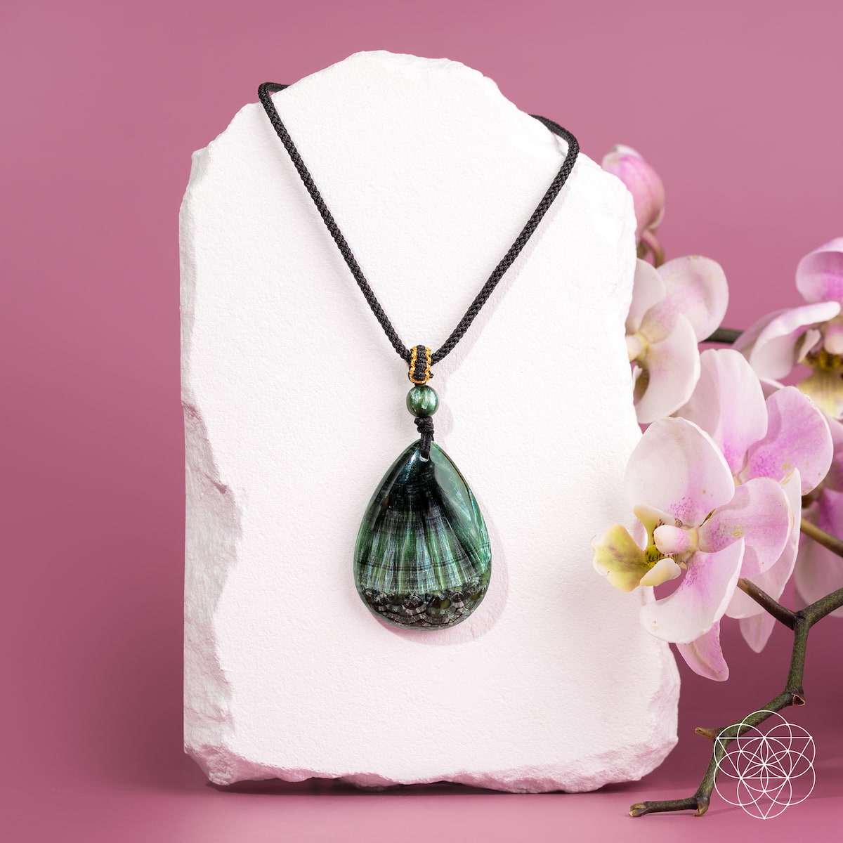 Seraphinite pendant necklace from Conscious Items featuring The Angel By My Side design, showcasing a green, shimmering gemstone on a silver chain.