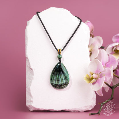 Seraphinite pendant necklace from Conscious Items featuring The Angel By My Side design, showcasing a green, shimmering gemstone on a silver chain.